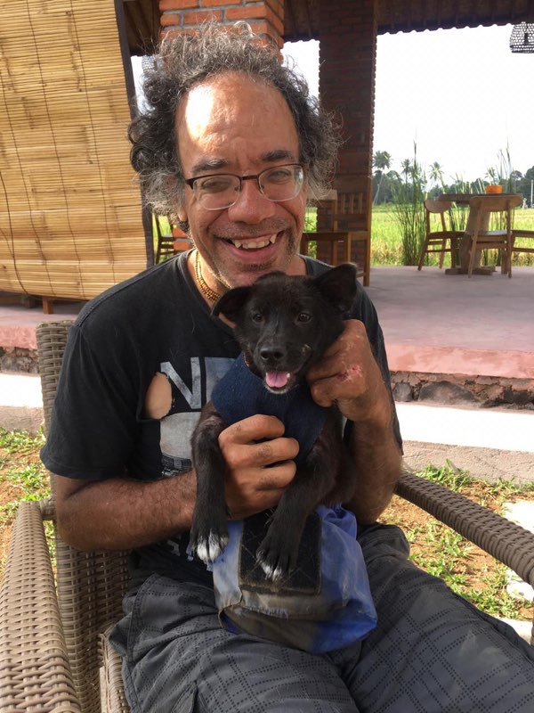 Kenneth holding a rescued puppy in Bali